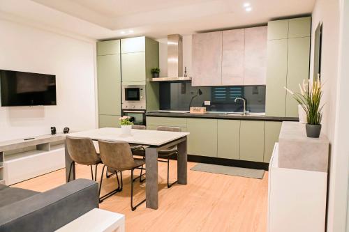 a kitchen and living room with a table and chairs at HABITAT- Apartments&Rooms in Cerignola