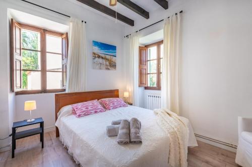 a bedroom with a bed with two towels on it at Can Xeliu in Sóller