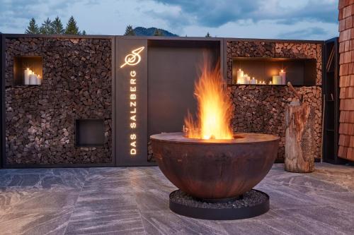 a large fire pit in front of a building at DAS SALZBERG Hideaway Bad Aussee - Adults only in Bad Aussee