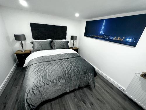 a bedroom with a bed and a large painting on the wall at New osborne hot tub and jacuzzi suites in Blackpool
