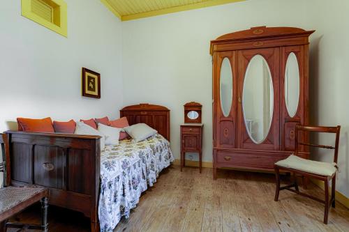 a bedroom with a bed and a dresser and a mirror at Casa Dorothea in Cercal