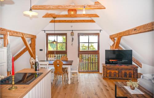 a living room with a table and a tv at 2 Bedroom Stunning Apartment In Mozirje in Mozirje