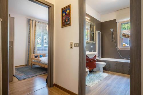 a bathroom with a toilet and a sink and a tub at Villa Vittoria Mountain View in Breguzzo