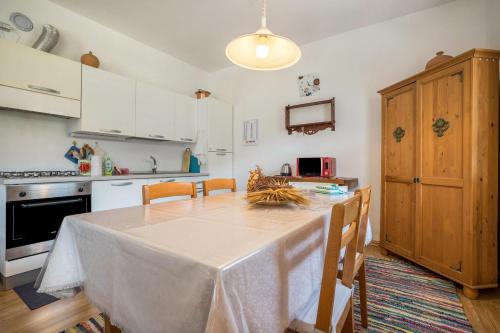 a kitchen with a table with a white table cloth on it at Villa Vittoria Mountain View in Breguzzo