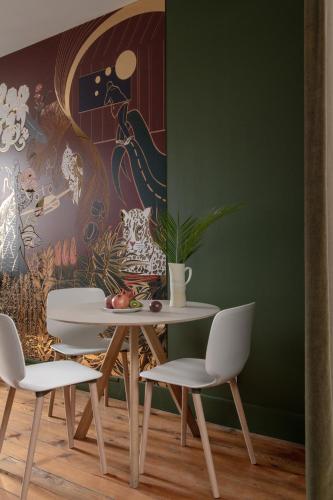 a dining room with a table and two chairs at MiHotel Gailleton in Lyon
