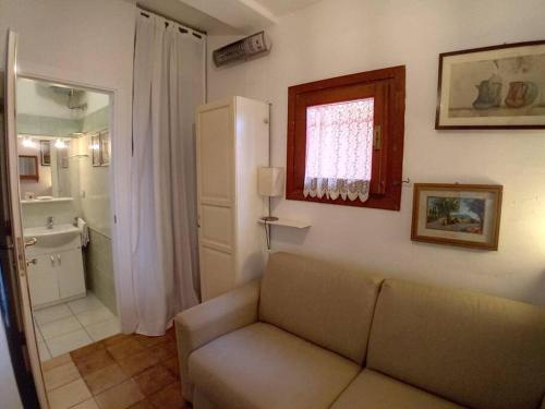 a living room with a couch and a bathroom at Belvedere-InfinityHolidays in Costa Paradiso