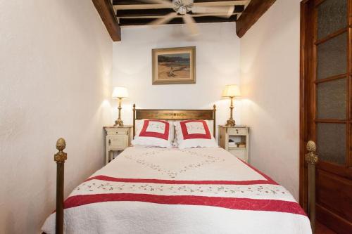 a bedroom with a bed with two red pillows at A8 Lovely 2br duplex in old Antibes 1min sea front in Antibes