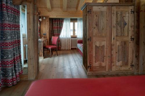 a living room with wooden walls and wooden floors and a door at Chalet Matterhorn Francois - Central Ski Chalet with SPA and Breakfast, 100mt lift in Breuil-Cervinia
