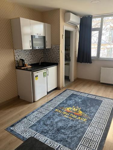 a kitchen with a rug on the floor at malibu palaca in Istanbul