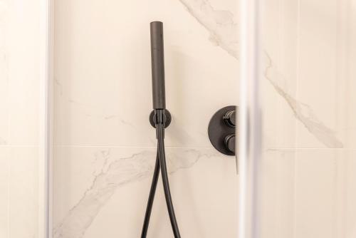a shower door with a black handle in a bathroom at TENUTA FOGLIANI Resort & Natural Spa in Visciano