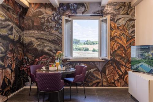 a dining room with a table and a window at TENUTA FOGLIANI Resort & Natural Spa in Visciano