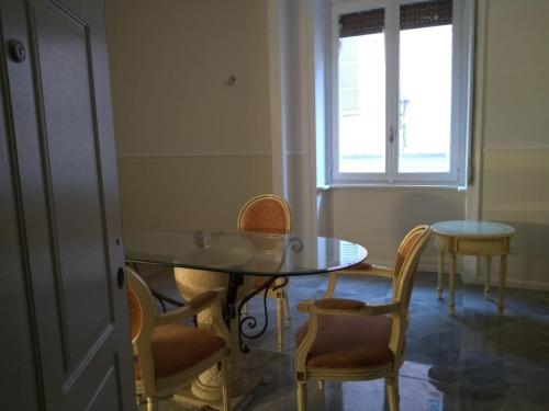 a dining room with a table and chairs and a window at PALAZZO NOVECENTO Centro Storico in Lecco