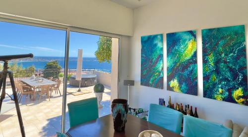 a dining room with a view of the ocean at Castel Horizon - Super Cannes - 360 Degrees View in Vallauris