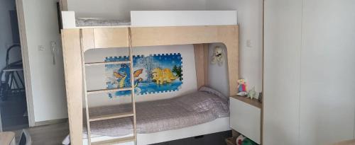 a childs bedroom with a bunk bed in a room at Central Park Apartment in Volos