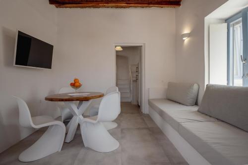 a living room with a couch and a table at Traditional White House in Prodromos Paros