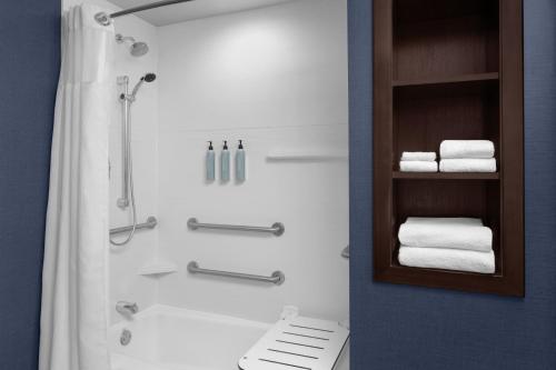 a bathroom with a shower and some towels at Residence Inn by Marriott Tustin Orange County in Tustin