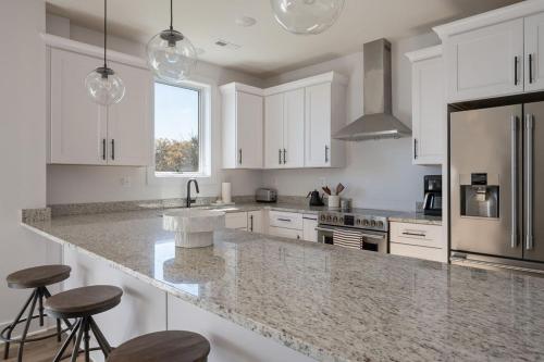 a kitchen with white cabinets and a granite counter top at Piedmont Place Suite 402 Modern Apartment in Heart of Crozet in Crozet
