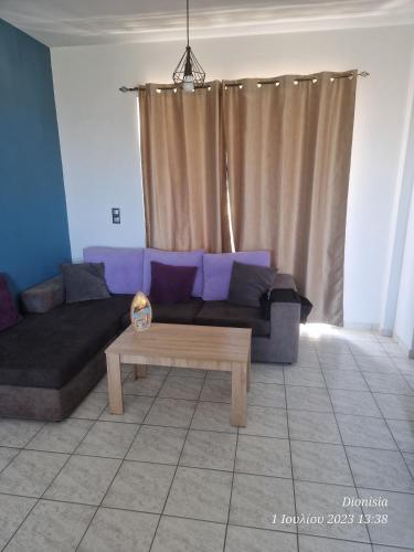 a living room with a couch and a coffee table at FILIANTHI in Kos Town