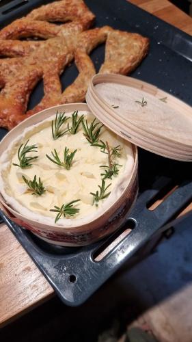 a bowl of food with rosemary on it next to bread at La Grange - Gite Mur de Barrez in Mur-de-Barrez