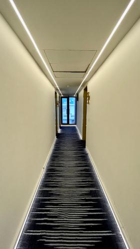 an empty hallway with a long hallway sidx sidx sidx at Hotel Limon & Banquet Sector 29, Gurgaon in Gurgaon