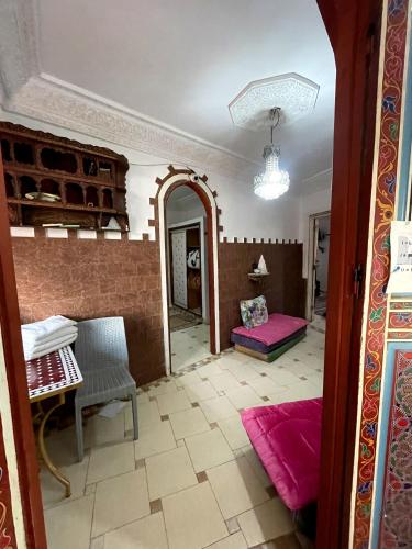 a living room with a fireplace and a mirror at Riad Malak in Meknès