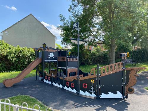 a small playground with a slide and a play structure at Stansted Coach House - Apartment Hotel in Elsenham