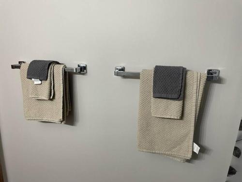 three towels hanging on a towel rack in a bathroom at One Bedroom Main floor Apartment in Camrose
