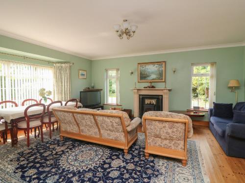 a living room with a couch and a table and chairs at Bolger House in Blackwater