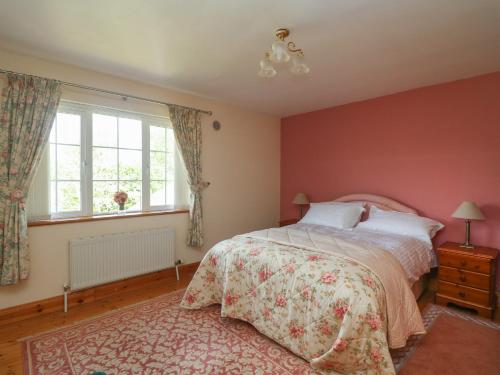 a bedroom with a bed and a window at Bolger House in Blackwater