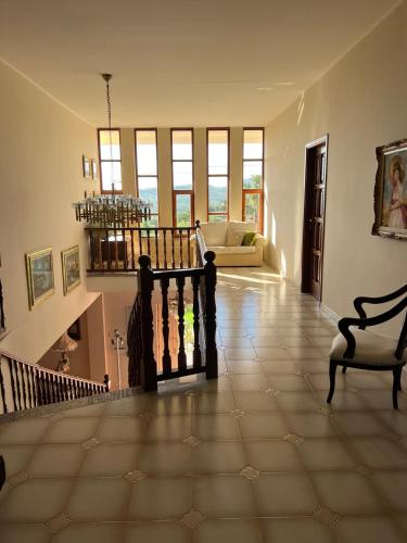 a living room with a staircase and a couch at Villa Marina B&B in Cleto