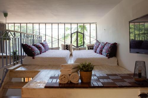 a living room with two beds and a balcony at Harmony Inn in Safed