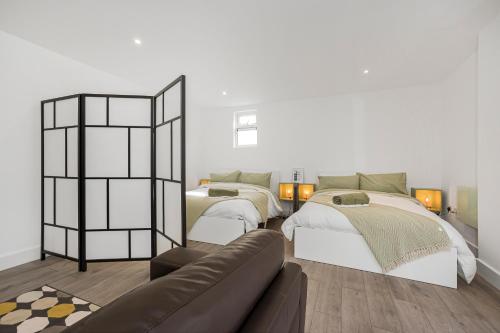 a living room with two beds and a couch at London Haven at Rutland House in Ilford