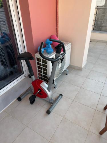 a room with a exercise bike next to a window at Sissi Olive home in Sissi