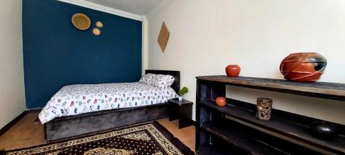 a bedroom with a bed and a table in a room at Comfy House 5 mins to Bole Airport in Addis Ababa