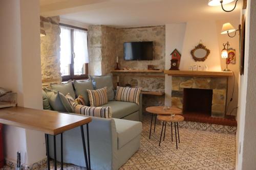 a living room with a couch and a fireplace at Martinis House in Pefkochori