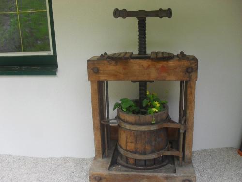 a wooden wine barrel with a plant in it at Bio-Bergbauernhof Möslhof in Aigen im Ennstal