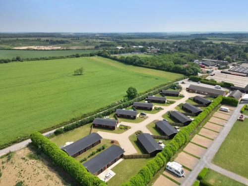 an aerial view of a farm with a row of solar panels at Sycamore Lodge in Oakham