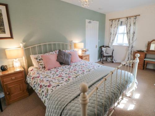 a bedroom with a bed with pink pillows on it at Sawdon Heights in Sawdon