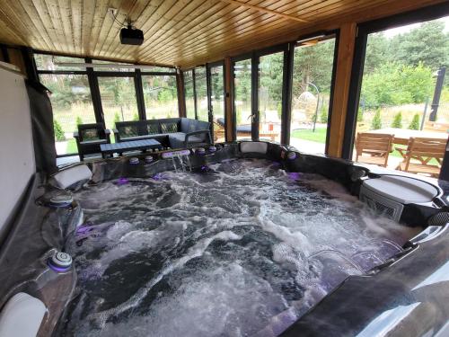 a hot tub in the middle of a house at LoveLake dom z jacuzzi in Radzyń