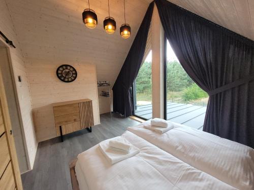 sypialnia z 2 łóżkami i dużym oknem w obiekcie LoveLake dom z jacuzzi w mieście Radzyń
