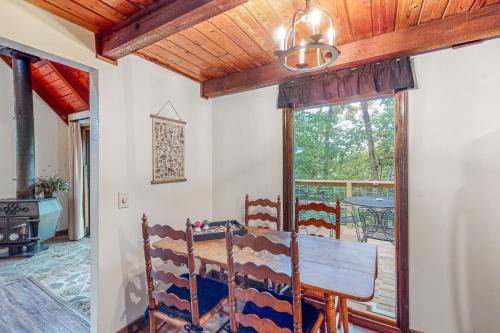 a dining room with a table and a window at Adventure Awaits in Rogers