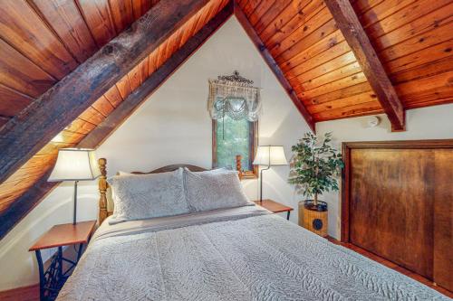 a bedroom with a bed and wooden ceilings at Adventure Awaits in Rogers