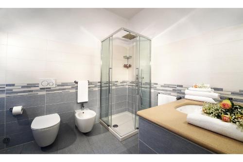 a bathroom with a shower and a toilet and a sink at La Rosa nel Borgo in La Morra