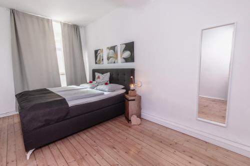 a bedroom with a bed and a mirror at Adam&Eva in Bamberg
