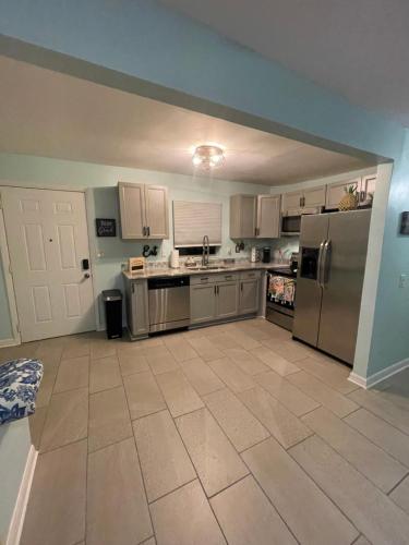 a large kitchen with stainless steel appliances at The Cocoa Cottage in Cocoa
