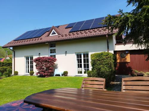 a house with solar panels on the roof at Molonówka Guest House in Szczyrk