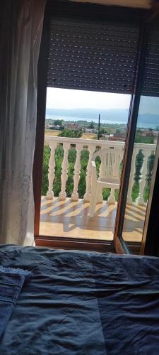 a bedroom with a window with a view of a balcony at Damjan's Apartments 