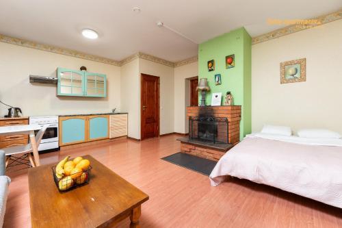a bedroom with a bed and a table with a bowl of fruit at Daily Apartments - Old Town Fat Margaret in Tallinn