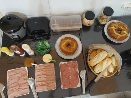 a table topped with different types of food and desserts at Rex Hotel in Marília