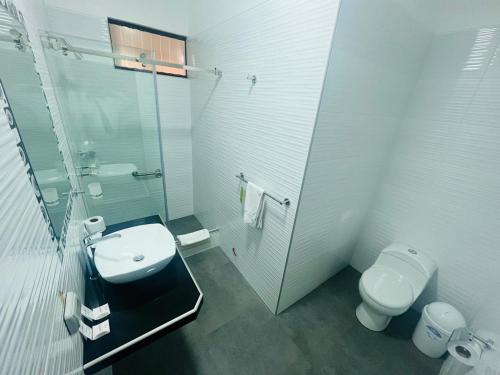 a bathroom with a toilet and a sink and a shower at Suites Larco 656 Miraflores Lima in Lima